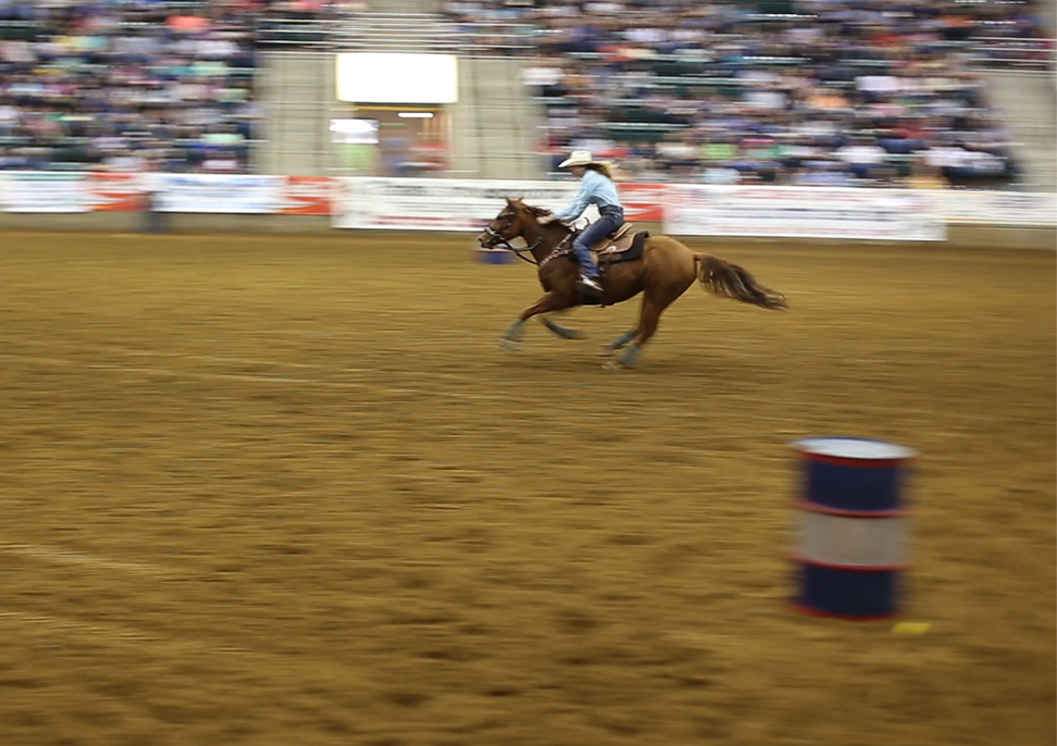 Barrel racing with horse.